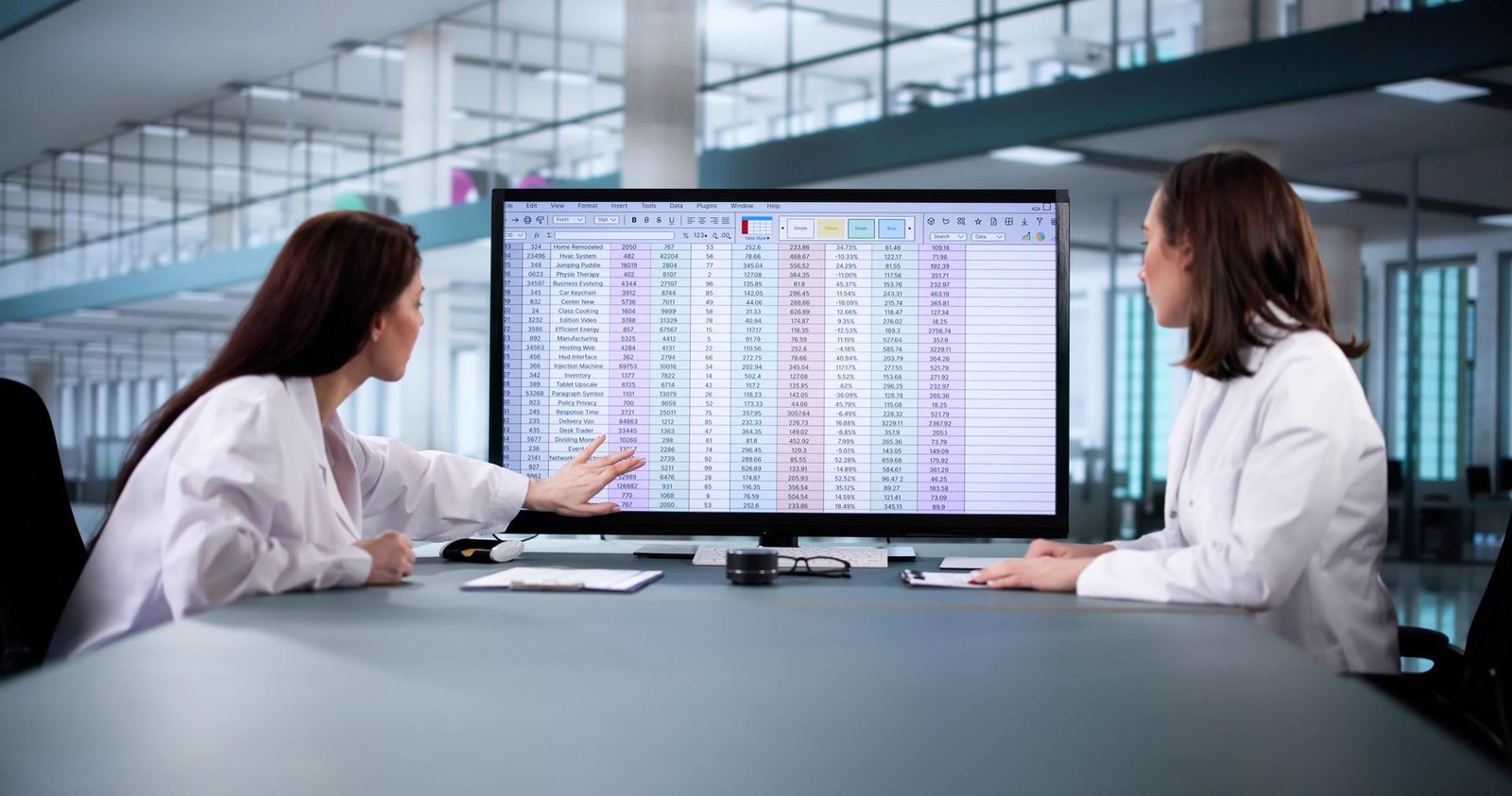 Revenue cycle team reviewing claim data on a large display